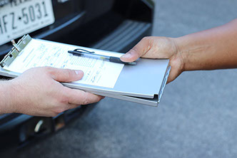 Security officer completing field documentation on a clipboard